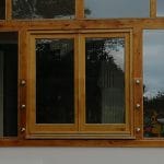 Frameless glass juliette balcony fixed to timber frame